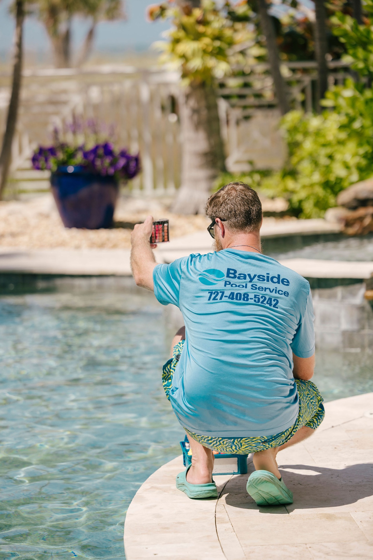 Bayside Pool Service technician checking water chemistry